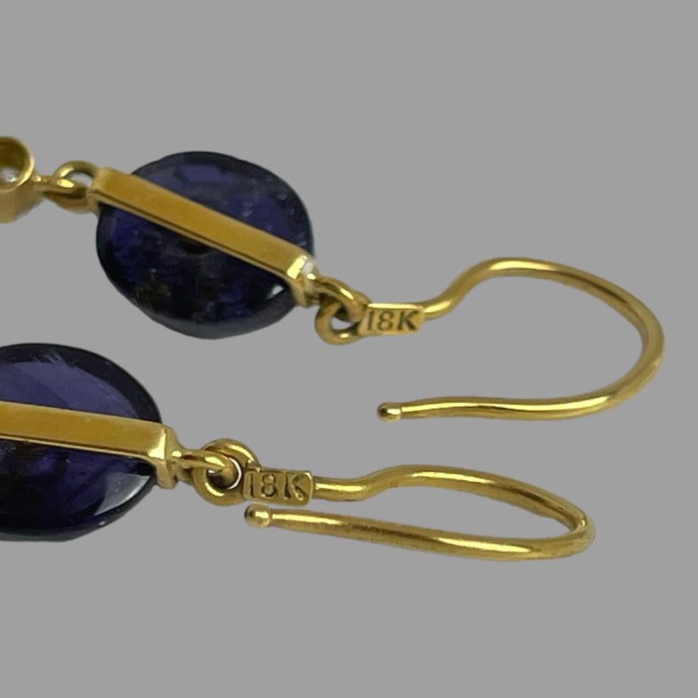 Close up photo of the 18k hallmark to the back of gold iolite diamond earrings hooks.
