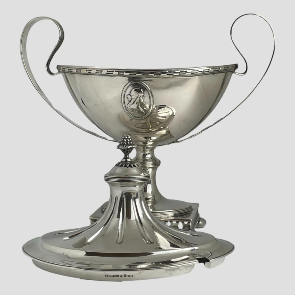 Photo of Swedish silver soup tureen with lid removed and placed in front of the main body. We are looking at the piece from an eye level.