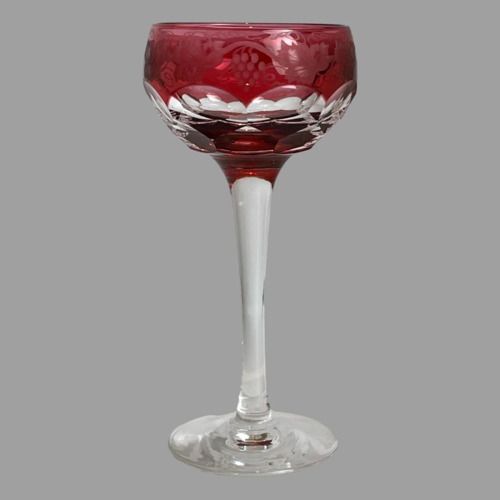 Main photo of etched cranberry wine glass seen from an eye level. The bowl of the