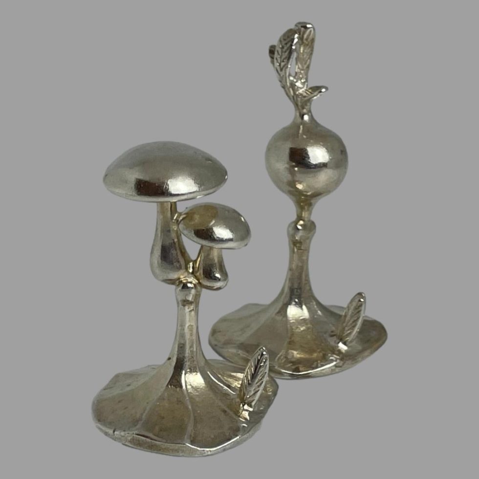 Close up photo of 2 of the Italian name card holders mushrooms on left and turnip on right to back.