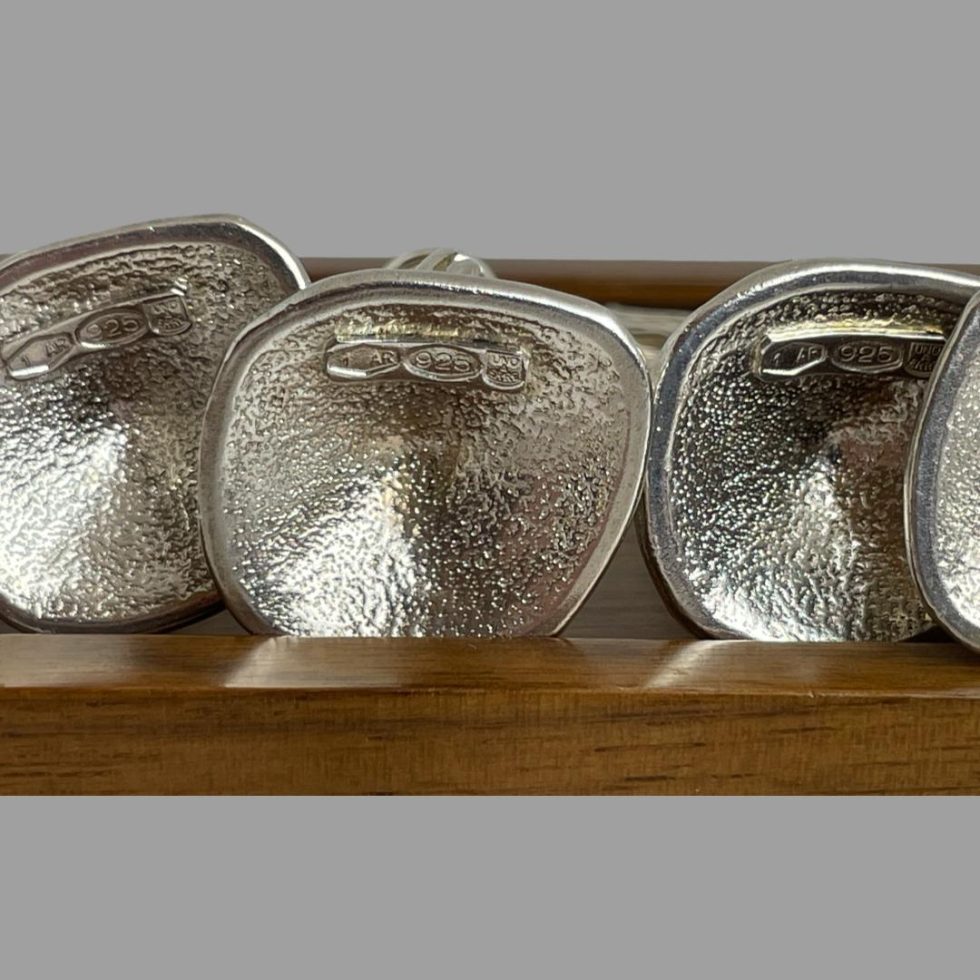 A close up photo of some of the hallmarks on the bases of the Italian name card holders.