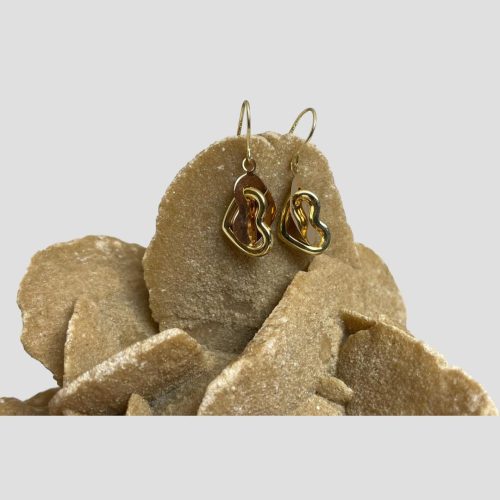 Main photo of 14kt gold heart earrings displayed hanging on a rock of natural desert rose . The earrings are hooked onto one of the desert rose 'petals' More detailed description of earring design in next close up photo.