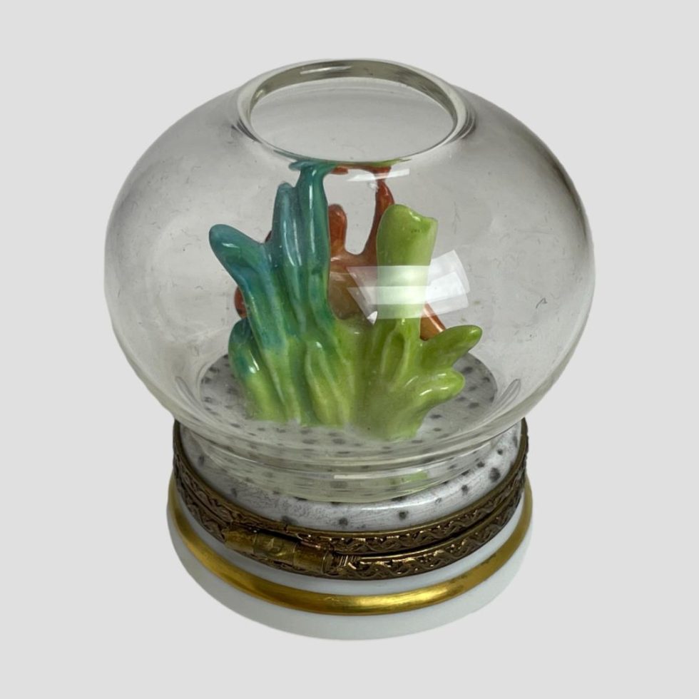 Photo of the back of Limoges goldfish bowl box with only the seaweed really visible - blue to the left, green to the right. Small areas of the fish can be seen between the seaweed.