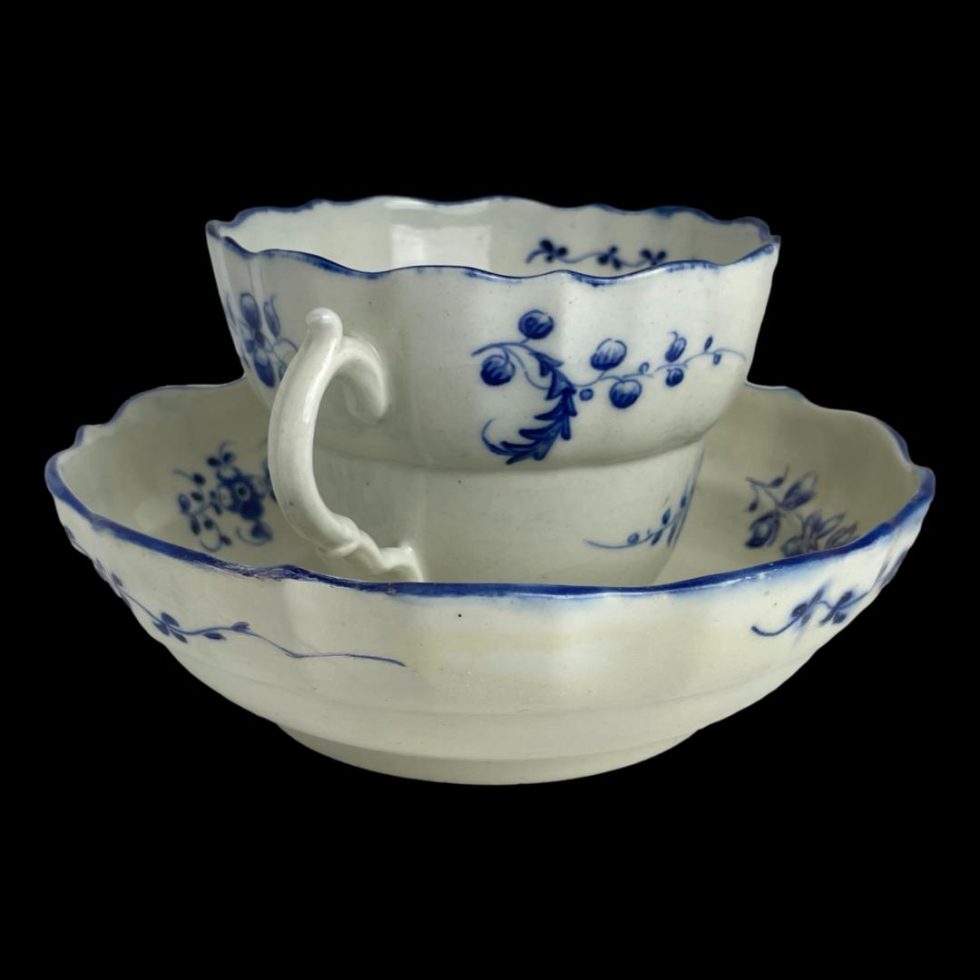 Photo of Caughley chocolate cup & saucer seen from a side angle with one of the 2 handles pointing to the bottom left corner.