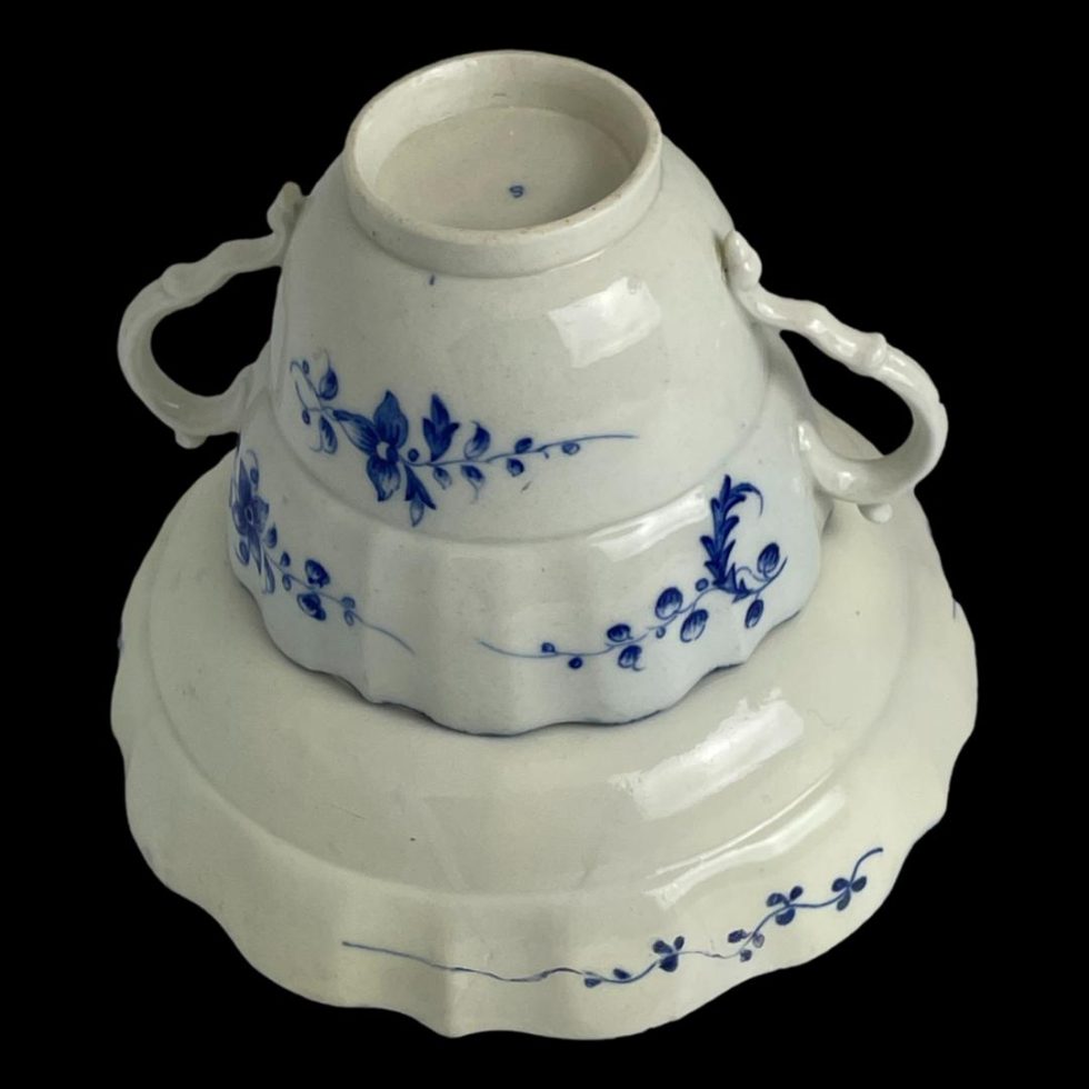 Photo of Caughley chocolate cup & saucer with the cup displayed face down on the of the saucer which is also face down. There are no marks to the base of the saucer and only the letter S on the base of the cup.