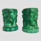 Main photo of malachite glass putti pots seen from an eye level with one side decoration of putti cherubs on show.