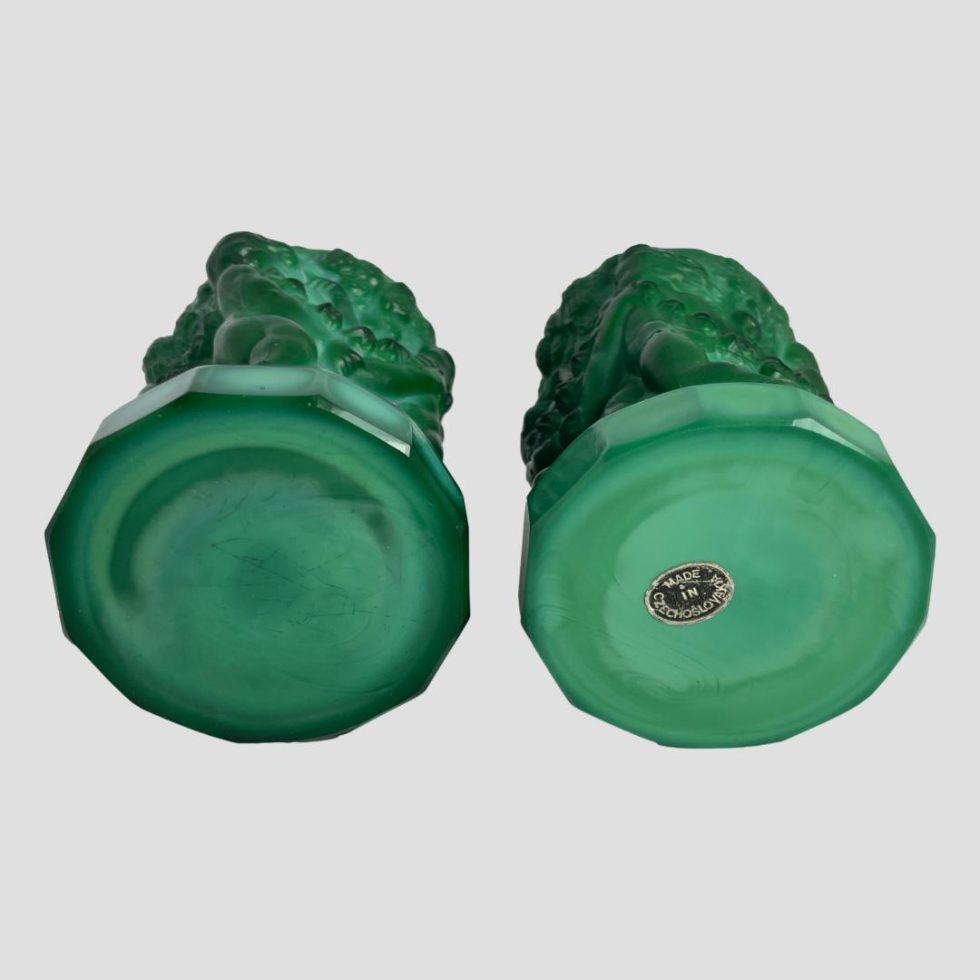 Photo of the base of both malachite glass putti pots with the original sticker visible to the one on right.