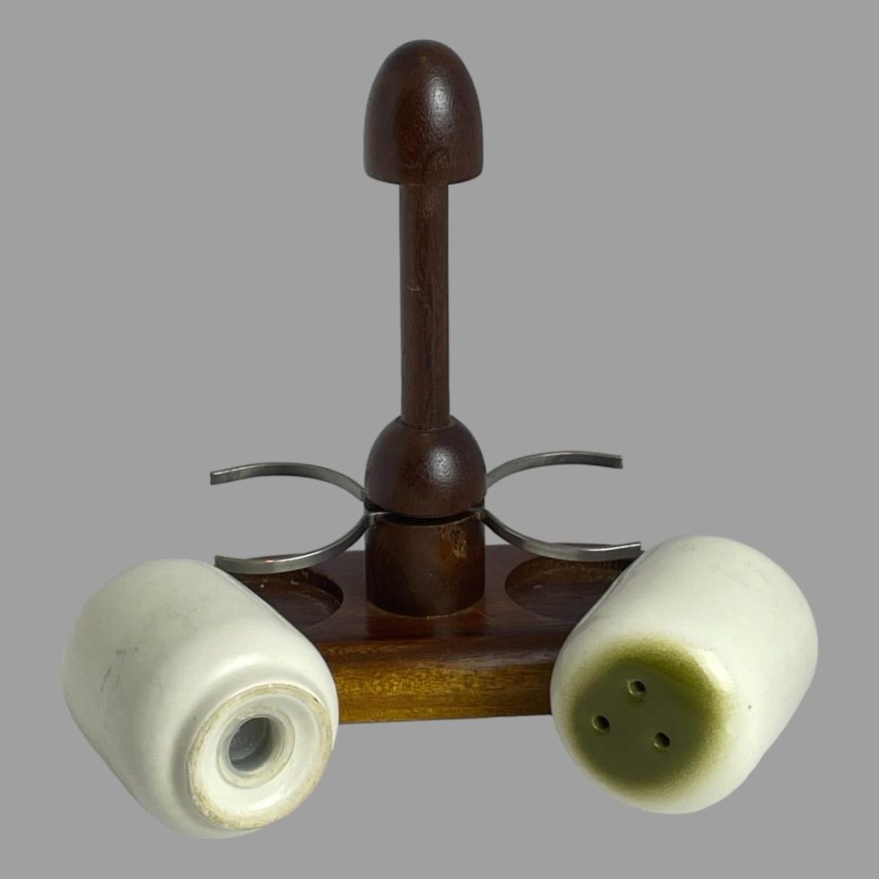 Photo of both salt and pepper pots removed from the wooden stand with one laid on the left with base showing and other laid to the right with top showing. Both pots have their stoppers.