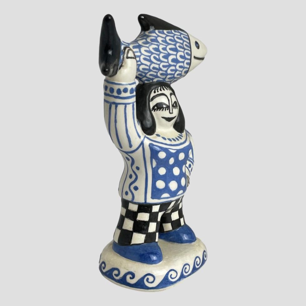 Photo of Bernard Moss fisherwoman figure seen turned slightly to the right so the tail of the fish and her raised arm is in the left foreground.