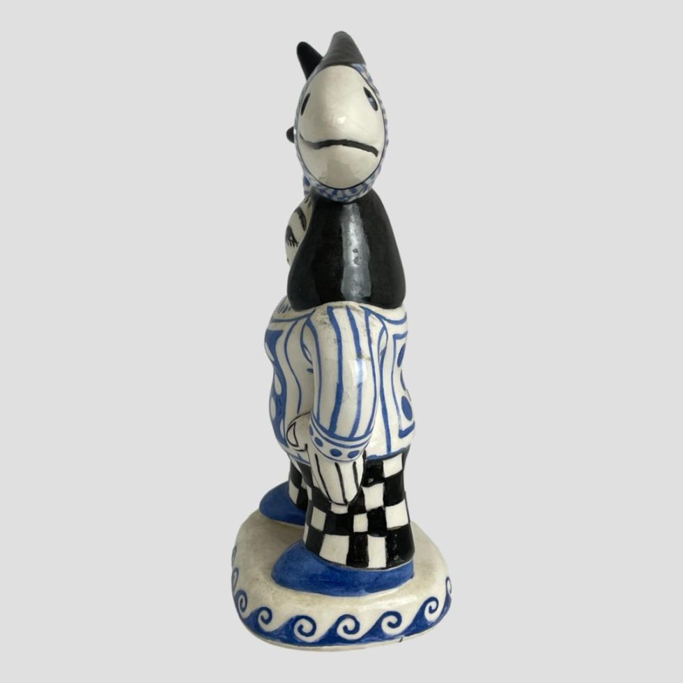 Photo of Bernard Moss fisherwoman figure seen from the side. She is is profile facing left while the fish is looking straight at camera.