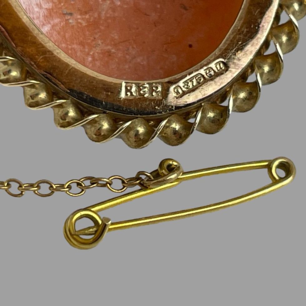 Close up photo of the hallmark on the back of the 9 karat gold cameo brooch.