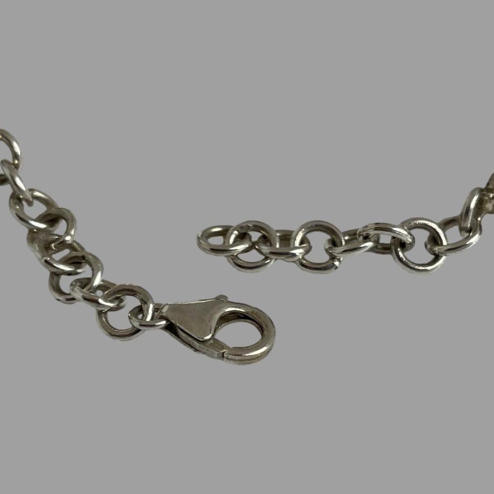 Close up photo of the 925 hallmark on the clasp of the sterling silver amethyst bracelet.