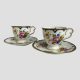Main photo of both Cauldon cups and saucers displayed side by side with one on right slightly more forward than other. The handles, both to the right, are shaped like the side view of butterfly wings which, given the butterfly theme makes a lot of sense! Beautiful hand-painted flowers adorn the front of the cups.