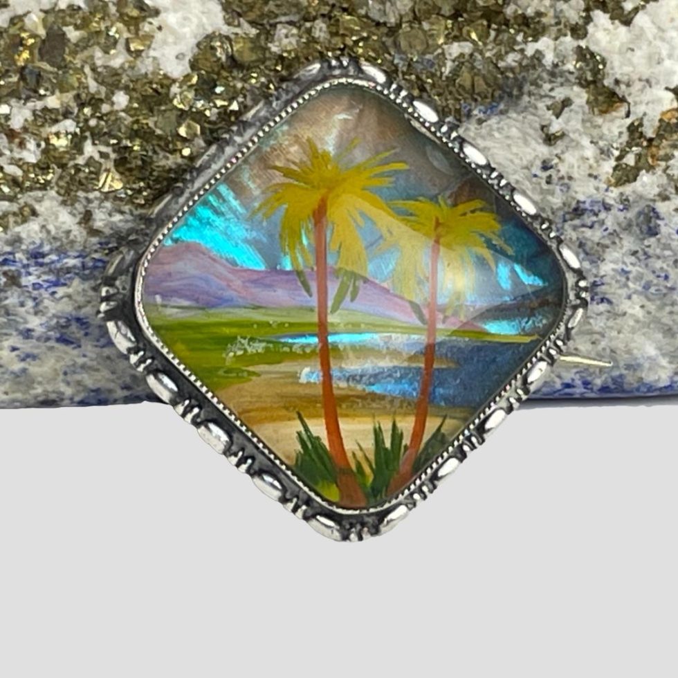 A close up of the image inside the silver butterfly wing brooch.