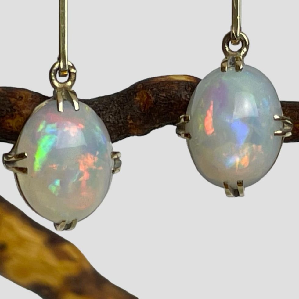 A close up photo of the opal cabochons and the incredible colour flashes within.