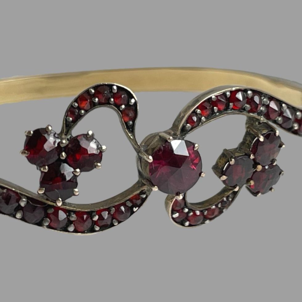 Close up photo of the 'bow area of antique garnet bracelet.