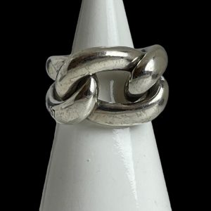 Main photo of Pomellato Gourmet knot ring displayed on a cone shaped white display stand with the ring front forward facing. This ring puts the chunk in chunky! A real statement piece in solid sterling silver. One 'rope' piece makes the shoulders and back bands of the ring while a 'rope circle' is interwoven for the ring front.
