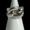 Main photo of Pomellato Gourmet knot ring displayed on a cone shaped white display stand with the ring front forward facing. This ring puts the chunk in chunky! A real statement piece in solid sterling silver. One 'rope' piece makes the shoulders and back bands of the ring while a 'rope circle' is interwoven for the ring front.