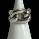 Main photo of Pomellato Gourmet knot ring displayed on a cone shaped white display stand with the ring front forward facing. This ring puts the chunk in chunky! A real statement piece in solid sterling silver. One 'rope' piece makes the shoulders and back bands of the ring while a 'rope circle' is interwoven for the ring front.